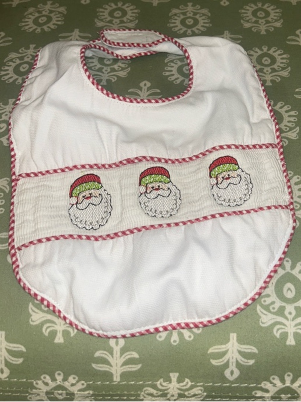 White Baby Bib with Santa Smocking and Red Trim